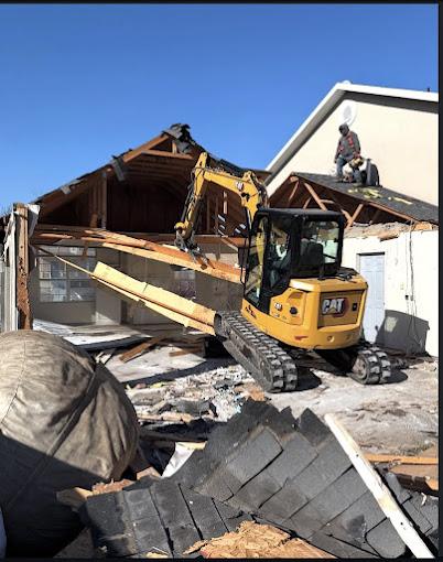 An excavator taking down an old structure