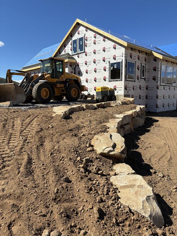 A boulder wall going in at a new construction home