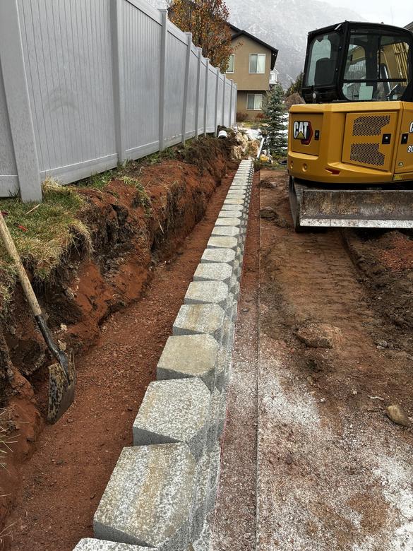 The base course of block set and leveled in the trench