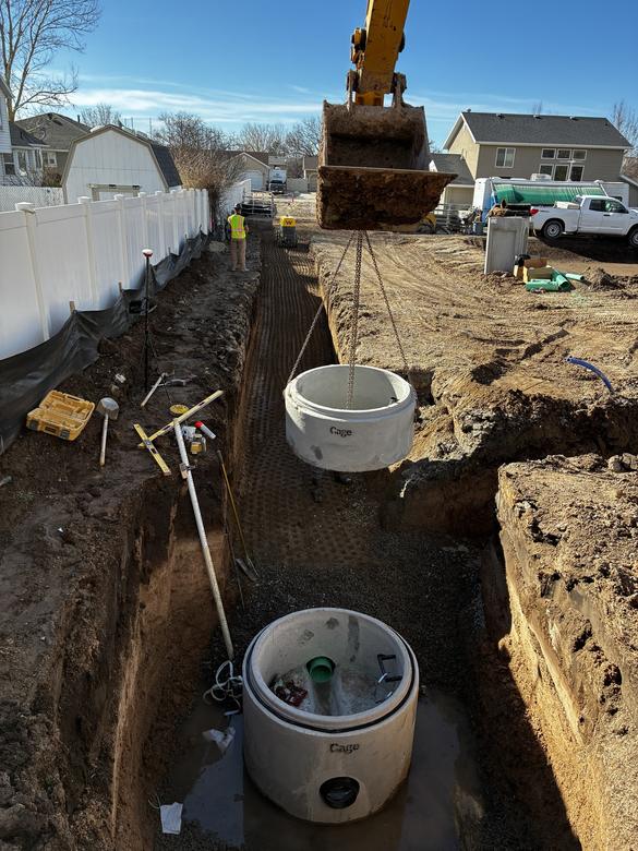 Setting a concrete manhole down in a deep trench