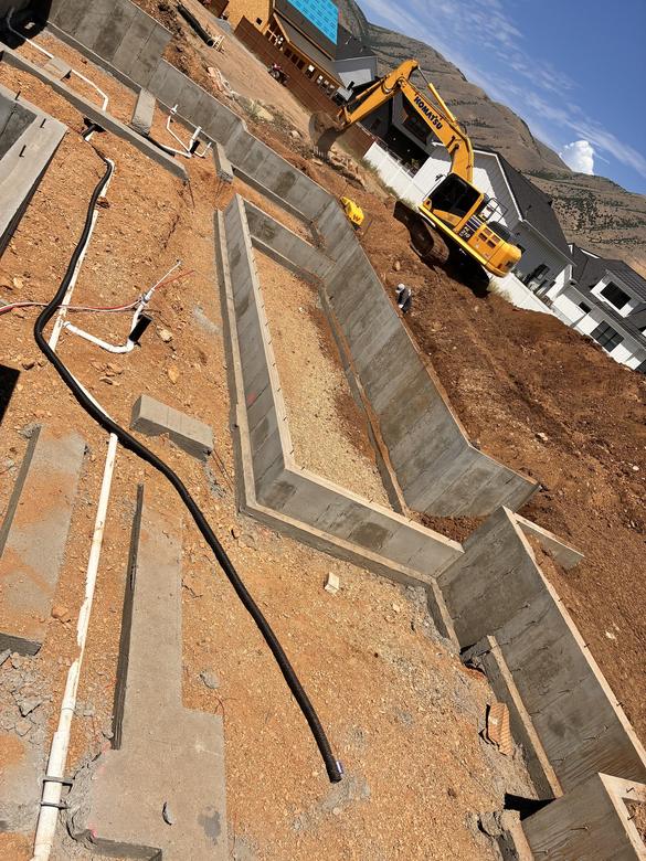 Drain pipe run at the footing of a stepped foundation