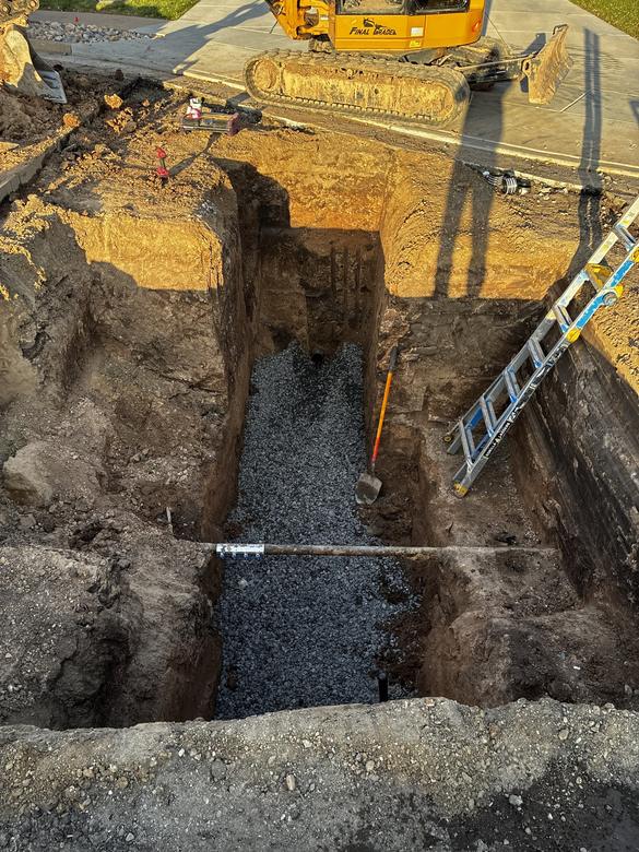 A drain trench bedded in clean gravel