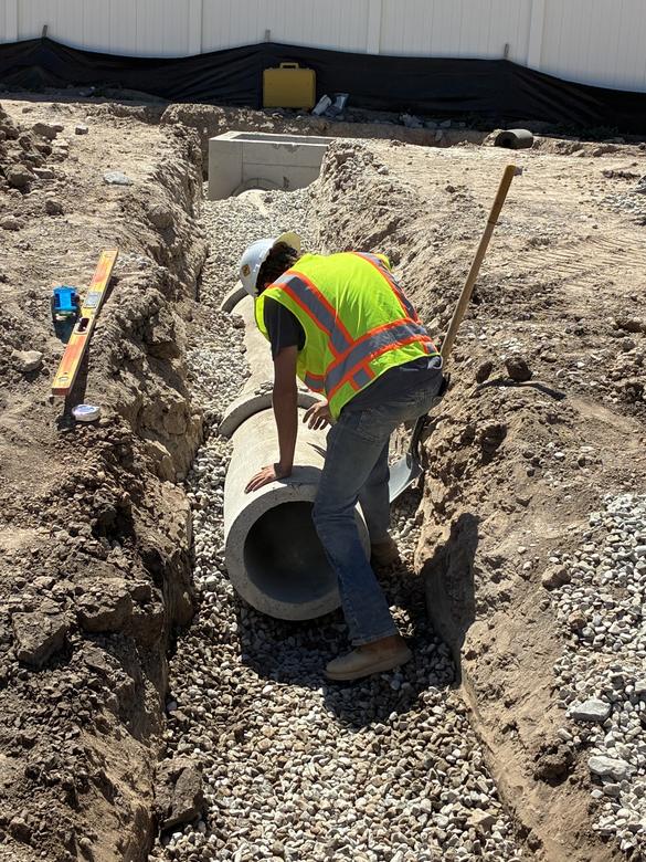Setting large concrete storm pipe in the trench